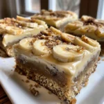 Close-up of several banana bread bars topped with brown butter frosting.