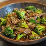 Close-up of a delicious teriyaki beef and broccoli stir-fry served over a bed of white rice.